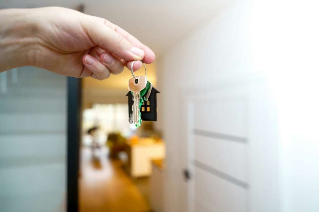 Home buyer holding the keys at the front door of their new Melbourne home