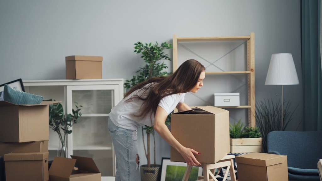 A person moving boxes into a new inner Melbourne home after buying