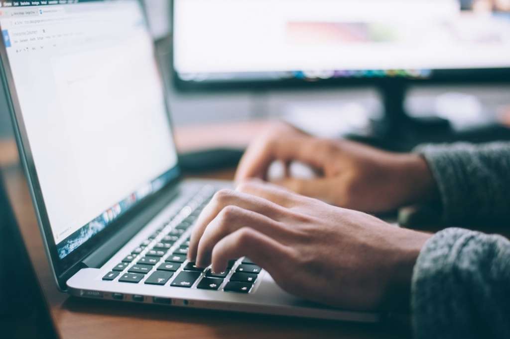 A person using a laptop to shortlist Melbourne suburbs with AI