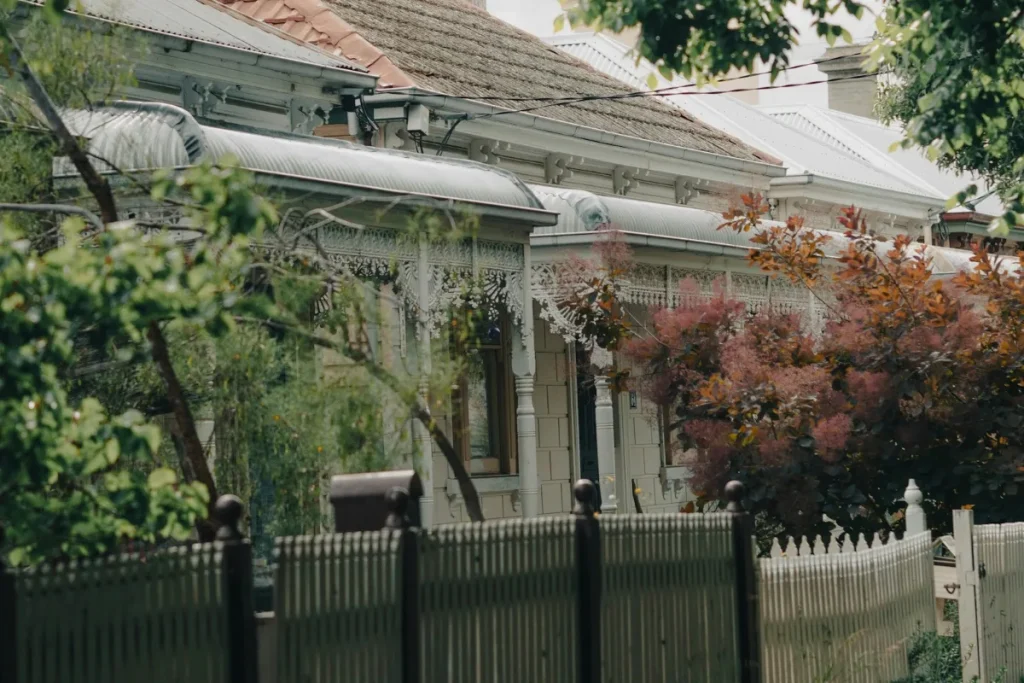 Victorian terrace house behind a picket fence in inner Melbourne